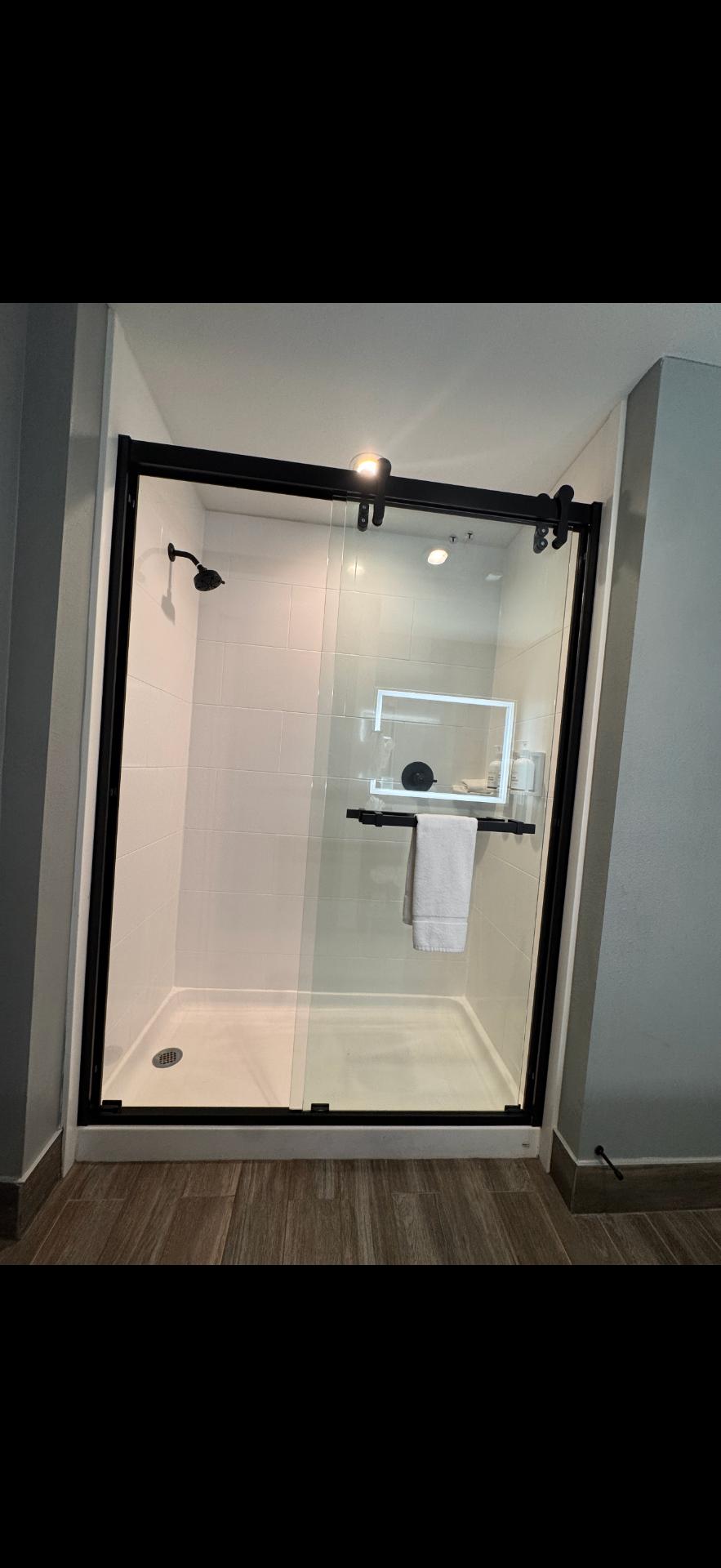 Walk-in shower with glass enclosure